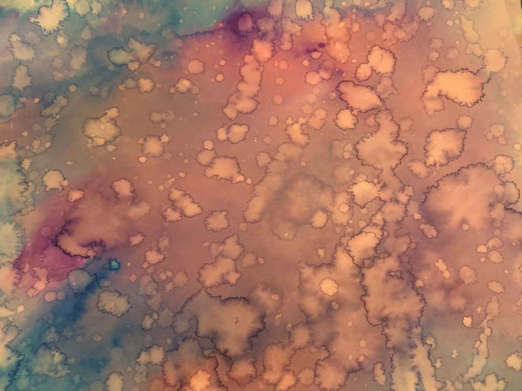 An abstract art piece of blended oranges, browns, and blues, with fainter water droplets on it (water rivulets and splatters).
